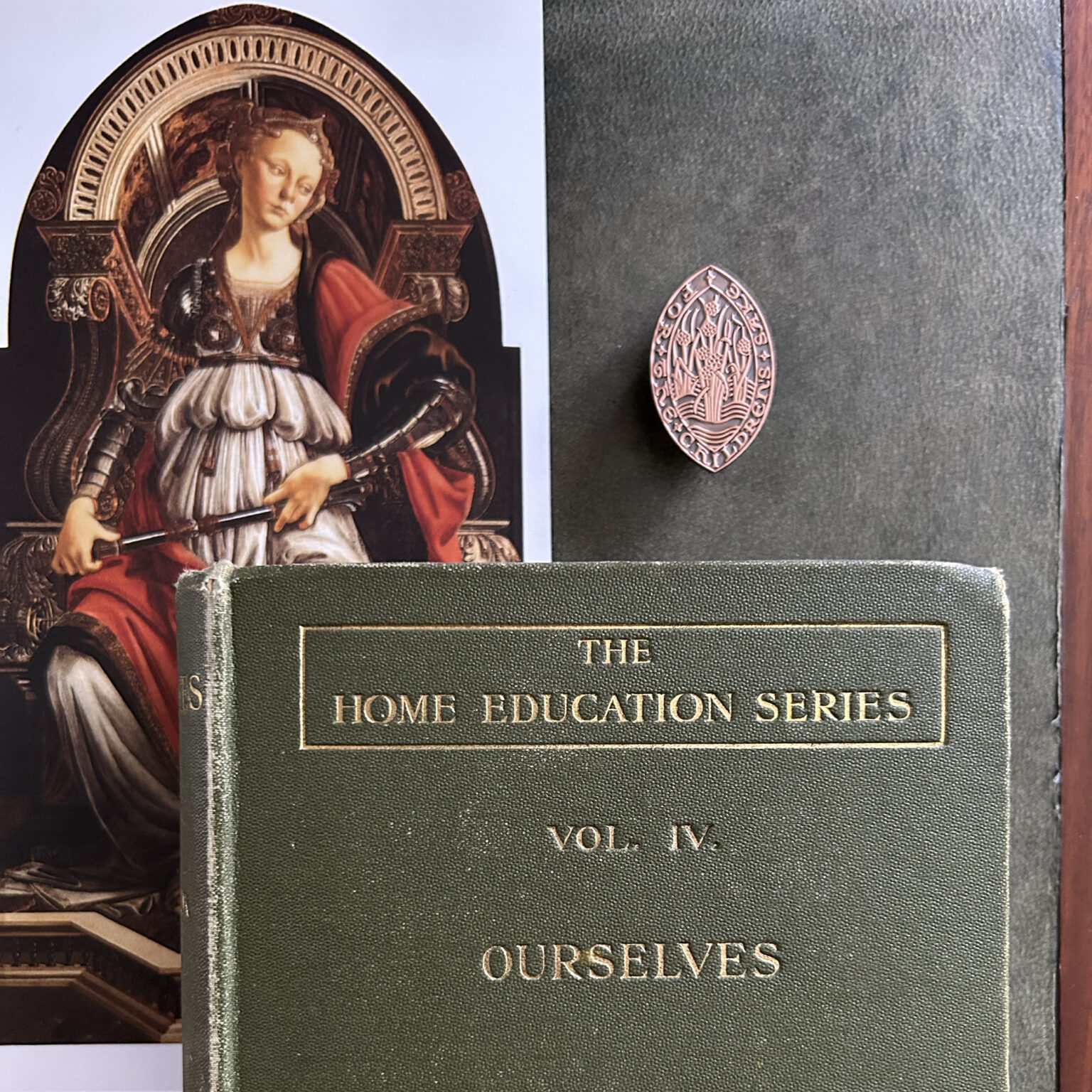 Portrait of a medieval woman in armor inside an elaborate circular frame on a book cover page art