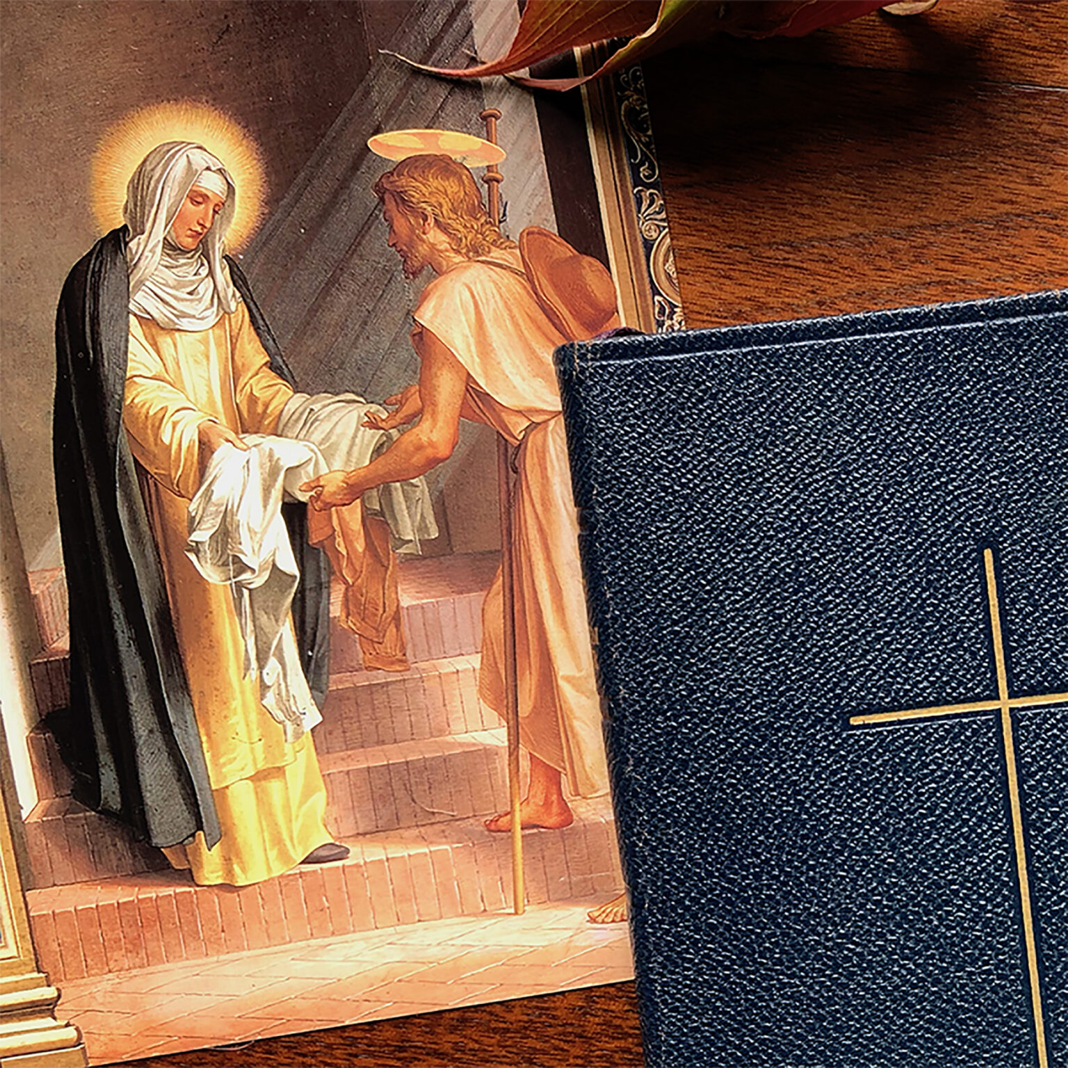 Religious painting showing a haloed figure in robes on the left and a kneeling robed figure with a halo on the right, framed by warm tones; a blue textured surface partially obscures the scene in the foreground.