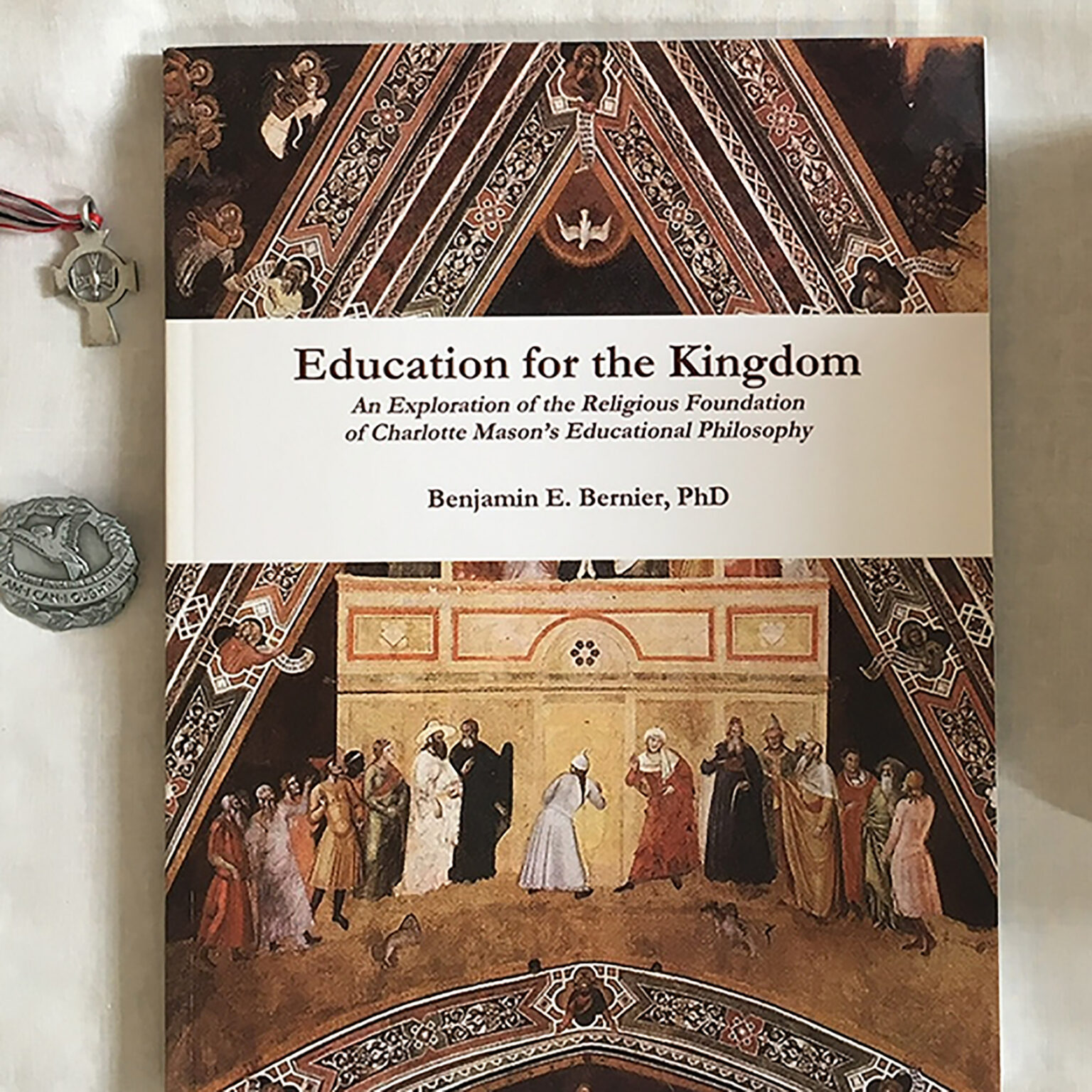 Book cover titled 'Education for the Kingdom' with an ornate architectural border and a crowd scene at the bottom.