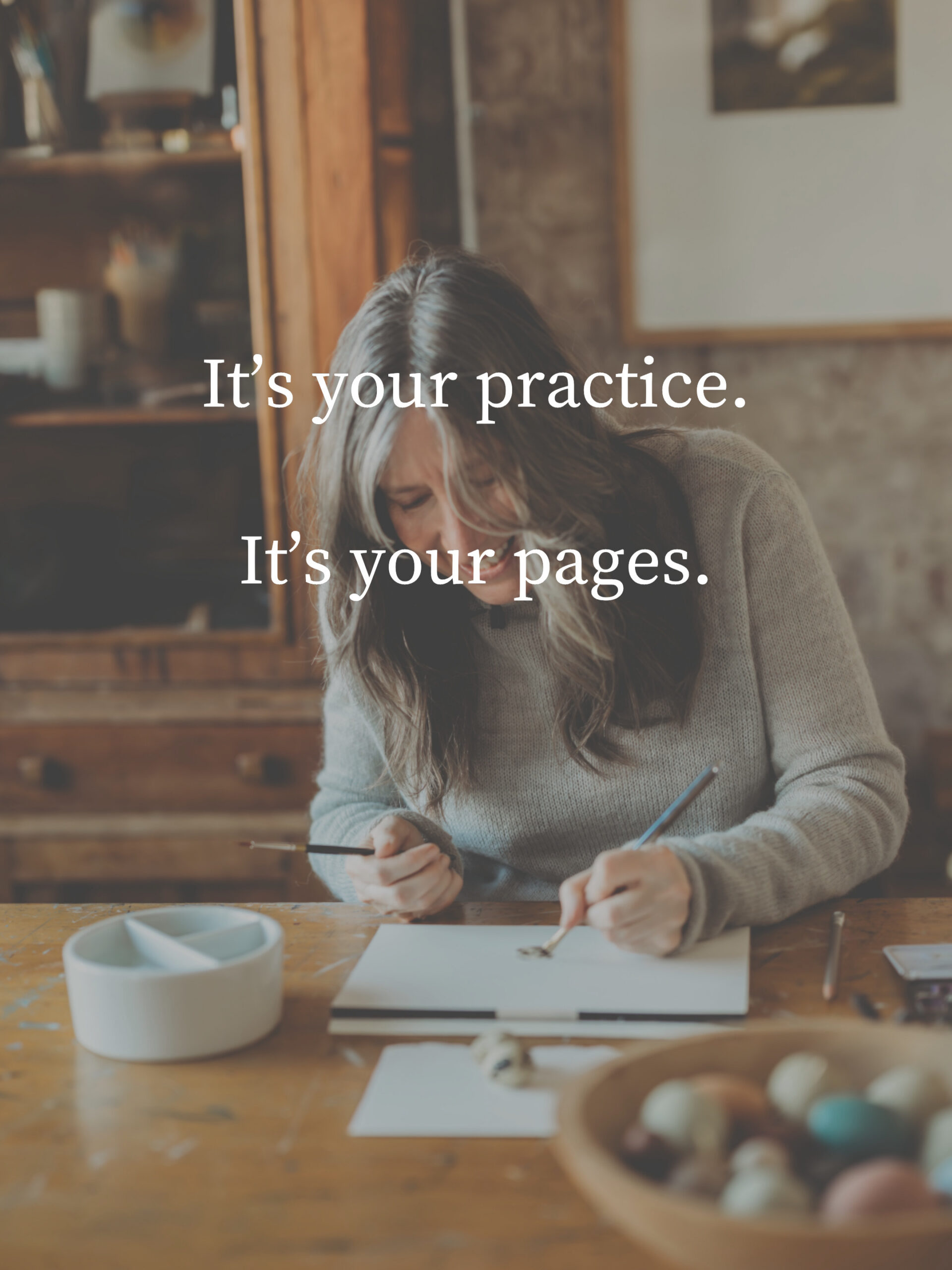 Overlaid text reads 'It’s your practice. It’s your pages.' as a woman sketches at a wooden table in a cozy studio.