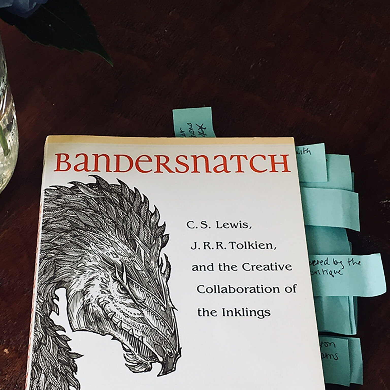 Book cover titled Bandersnatch in red letters with a detailed black-and-white illustration of a fantastical creature on the left; several blue sticky notes tucked into the pages.
