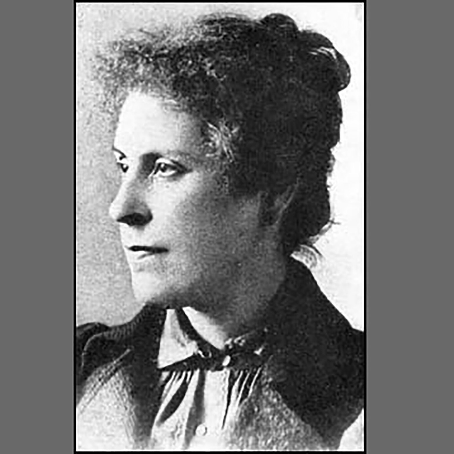 Black-and-white portrait of a woman in profile facing left, wearing a blazer.
